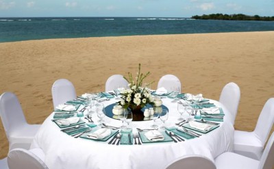 Theme party - white table set up on the beach